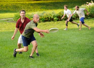 playing frisbee on state house lawn