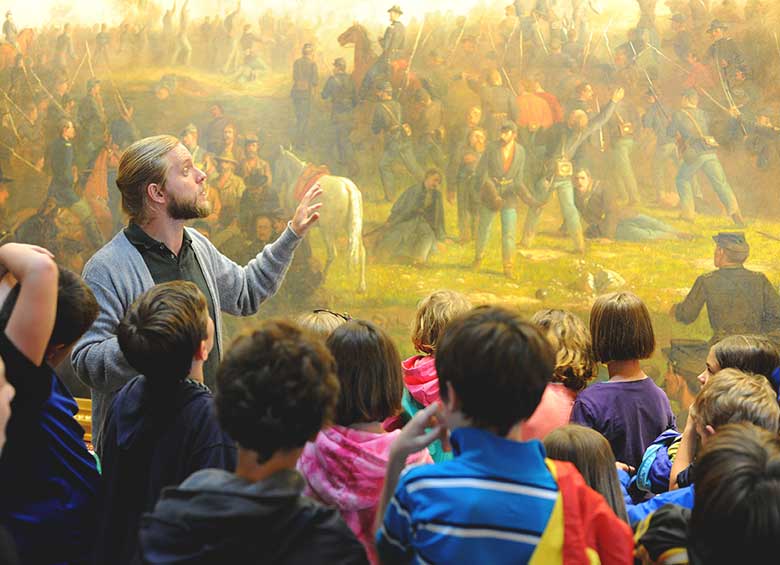 Museum staff teaching school children history of Vermont
